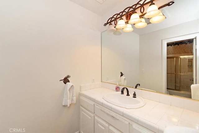 bathroom featuring an enclosed shower and vanity