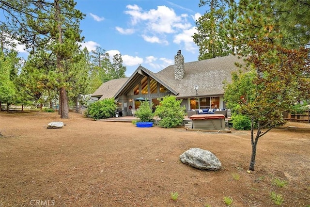 view of front of property with a hot tub and a patio