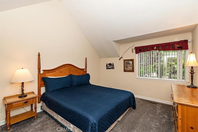 bedroom with vaulted ceiling and dark carpet