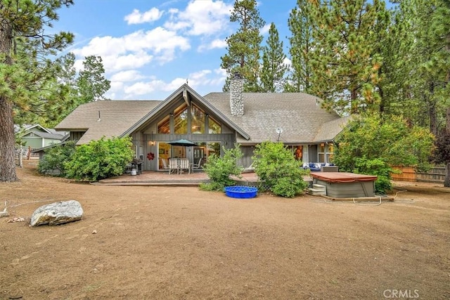 view of front of home with a hot tub and a patio