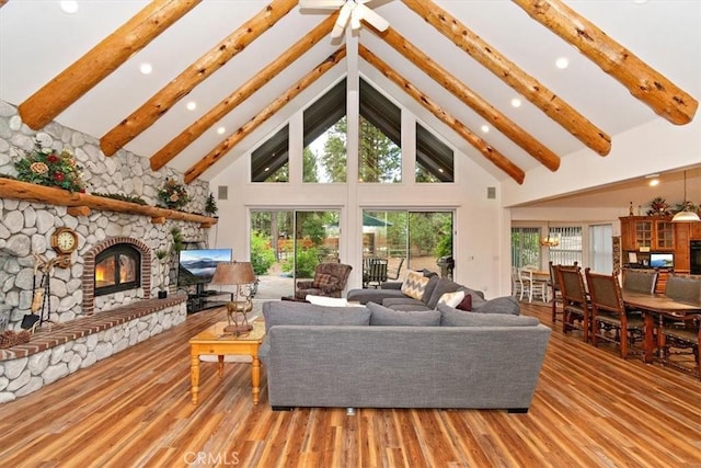 living room with hardwood / wood-style flooring, a fireplace, high vaulted ceiling, and beamed ceiling