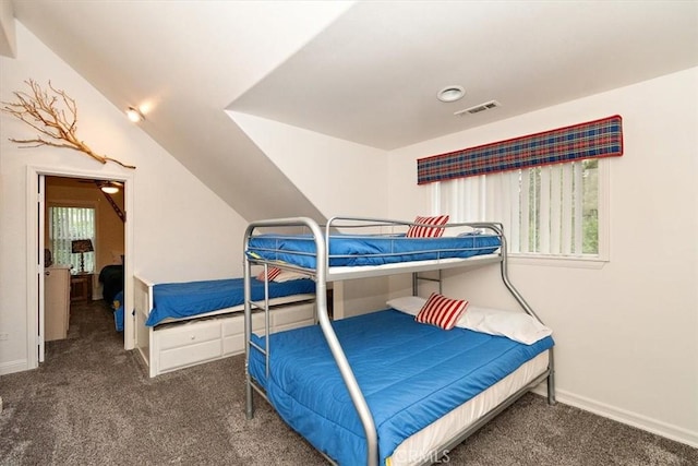 carpeted bedroom with lofted ceiling