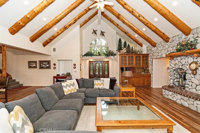 living room with hardwood / wood-style flooring, a fireplace, high vaulted ceiling, and beam ceiling