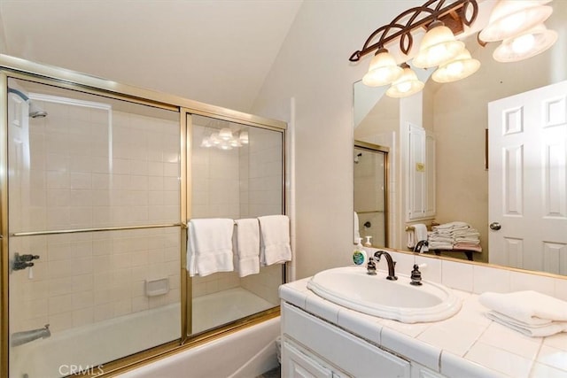 bathroom featuring vanity, lofted ceiling, and enclosed tub / shower combo