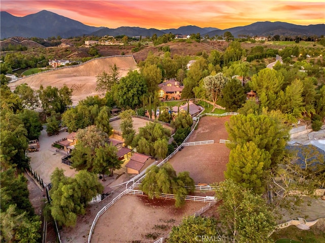 aerial view at dusk featuring a mountain view