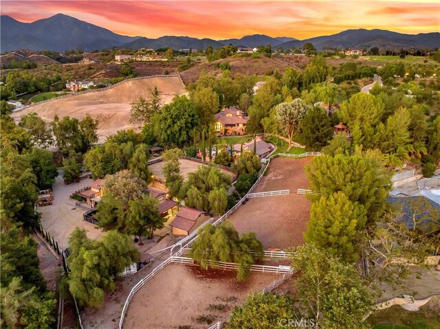 aerial view at dusk featuring a mountain view