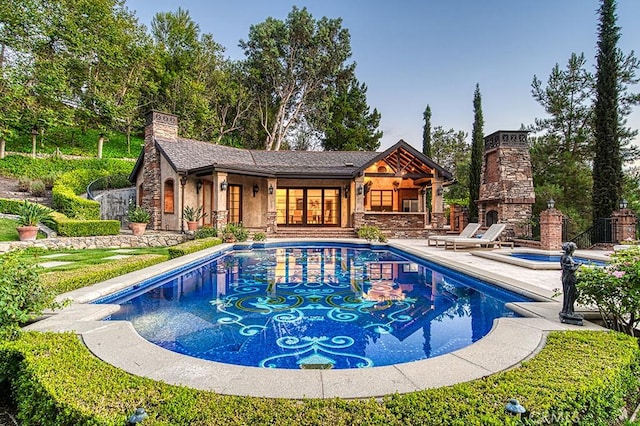 view of pool featuring a patio and an outdoor stone fireplace