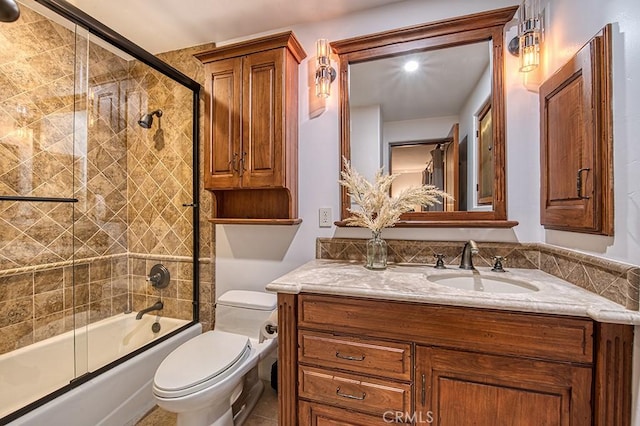 full bathroom with vanity, toilet, and combined bath / shower with glass door