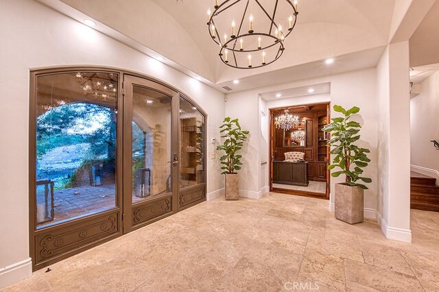 entrance foyer featuring lofted ceiling and baseboards