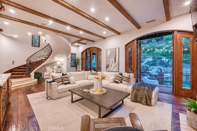 living room featuring beamed ceiling and wood-type flooring