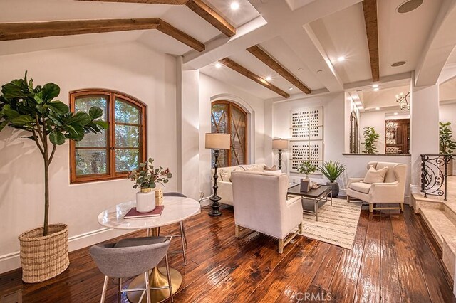 living area featuring lofted ceiling with beams, baseboards, and dark wood-style floors