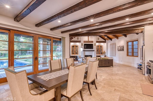 dining space featuring lofted ceiling with beams, recessed lighting, french doors, a fireplace, and baseboards