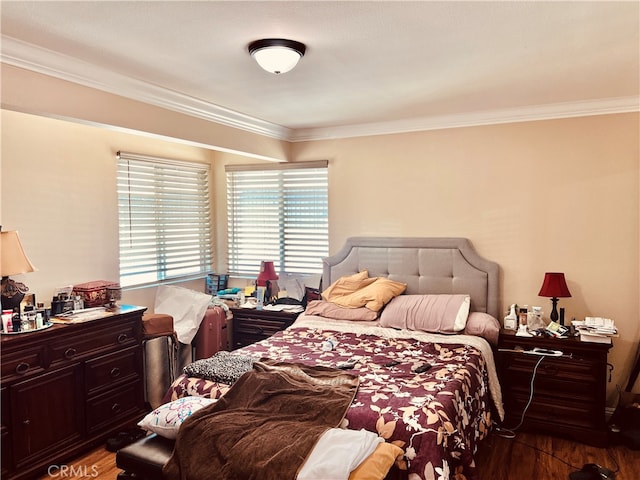 bedroom featuring wood-type flooring and crown molding