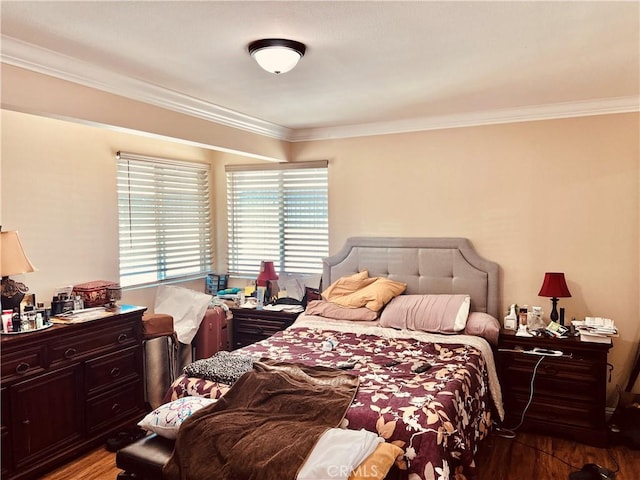 bedroom with crown molding and wood-type flooring