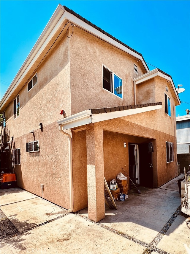 back of property with a patio