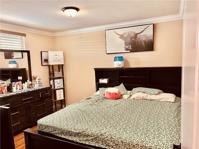 bedroom featuring ornamental molding and light hardwood / wood-style floors