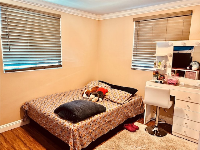 bedroom with crown molding and hardwood / wood-style flooring