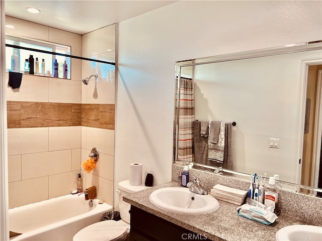 full bathroom featuring a textured ceiling, toilet, vanity, and shower / tub combo with curtain