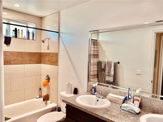 full bathroom with toilet, vanity, and shower / bath combination with curtain