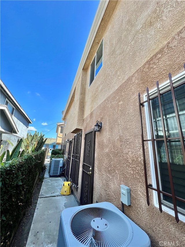 view of side of property featuring central AC