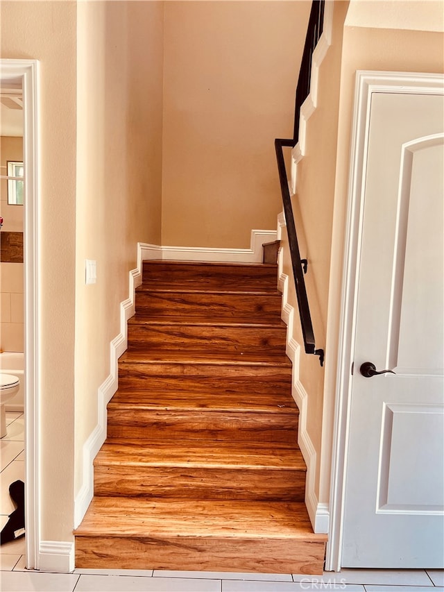 stairway with tile patterned floors