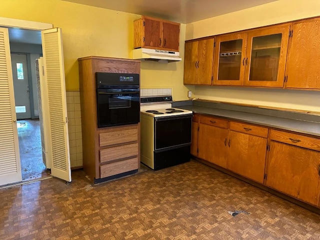 kitchen featuring dark parquet flooring, electric range, and oven