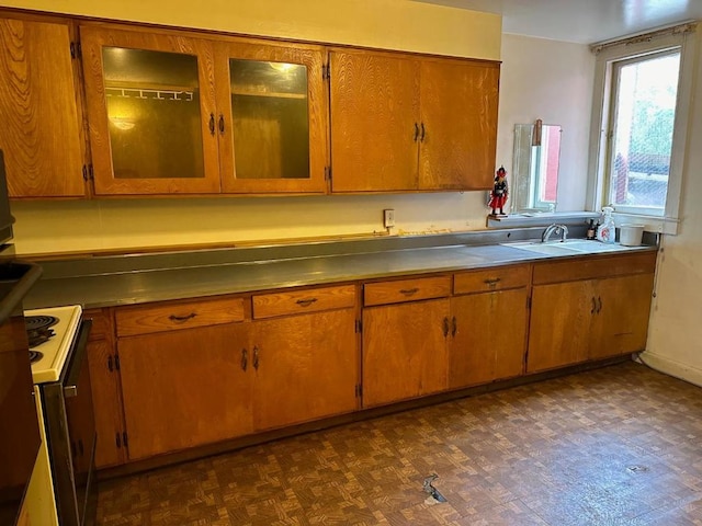 kitchen featuring white electric range, dark parquet flooring, and sink