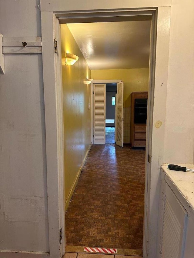 hall featuring dark parquet flooring