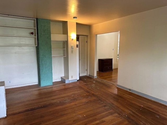 unfurnished bedroom with dark hardwood / wood-style flooring