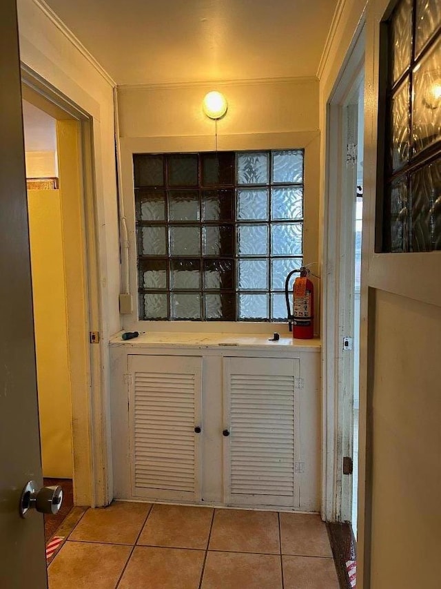 doorway to outside featuring light tile patterned flooring