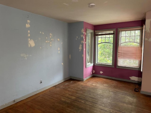 spare room with wood-type flooring