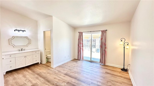 interior space featuring sink and light hardwood / wood-style flooring