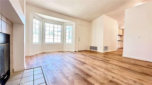 unfurnished living room featuring light hardwood / wood-style floors