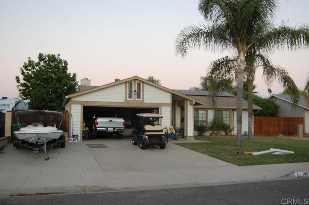 ranch-style home with a yard