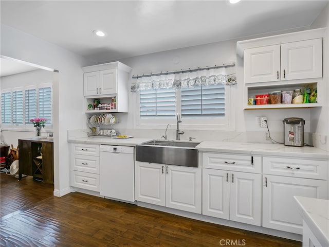 kitchen featuring dark hardwood / wood-style floors, dishwasher, sink, and a wealth of natural light