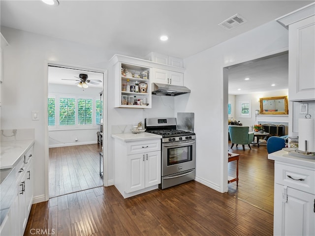 kitchen featuring gas stove, dark wood-type flooring, ceiling fan, and white cabinets