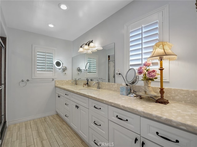 bathroom with vanity, hardwood / wood-style floors, and an enclosed shower