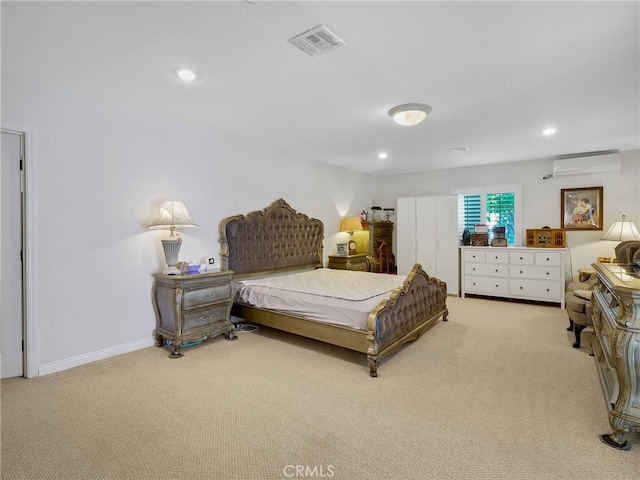 bedroom featuring a wall mounted AC and light carpet