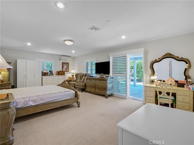 carpeted bedroom with access to outside and a wall unit AC