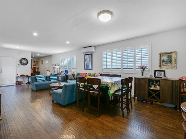 dining area featuring an AC wall unit and dark wood-type flooring