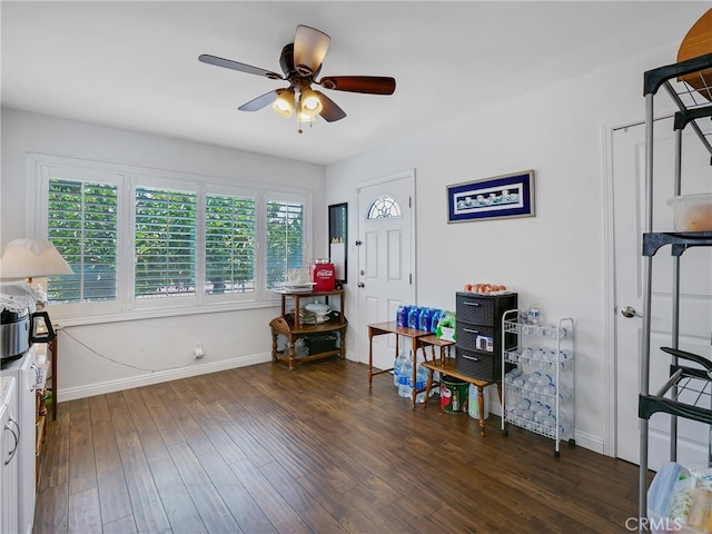 interior space featuring ceiling fan, dark hardwood / wood-style flooring, and a healthy amount of sunlight