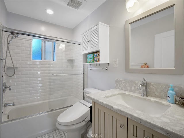 full bathroom featuring tile patterned flooring, shower / bath combination with glass door, vanity, and toilet