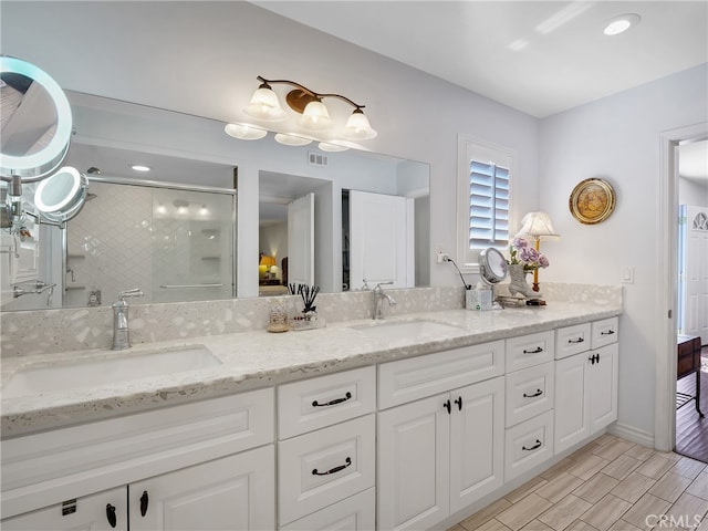 bathroom with walk in shower and vanity