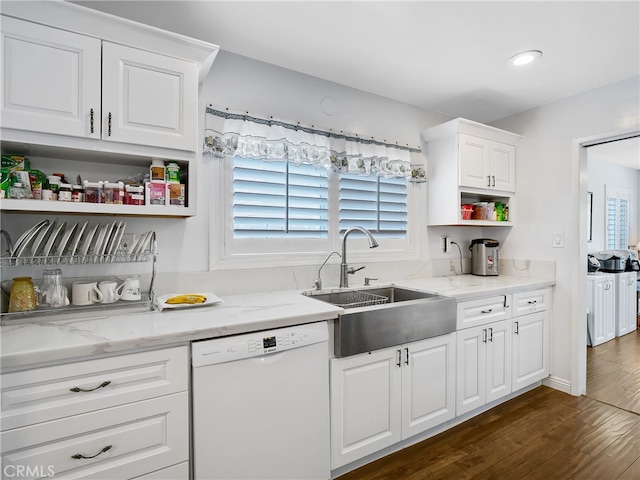 kitchen featuring light stone counters, dishwasher, sink, and dark hardwood / wood-style flooring