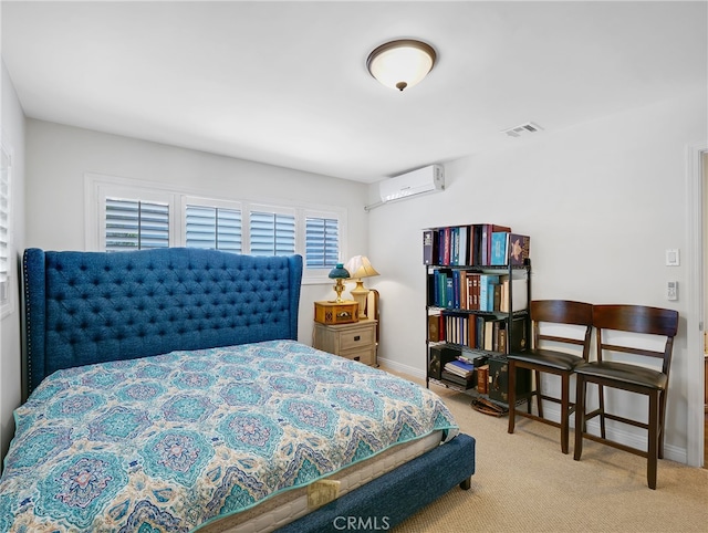 bedroom featuring light colored carpet and a wall mounted air conditioner