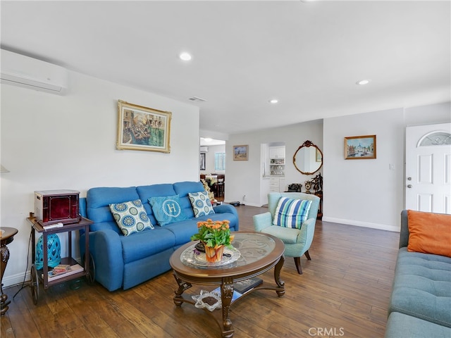 living room featuring dark wood-type flooring and a wall mounted AC