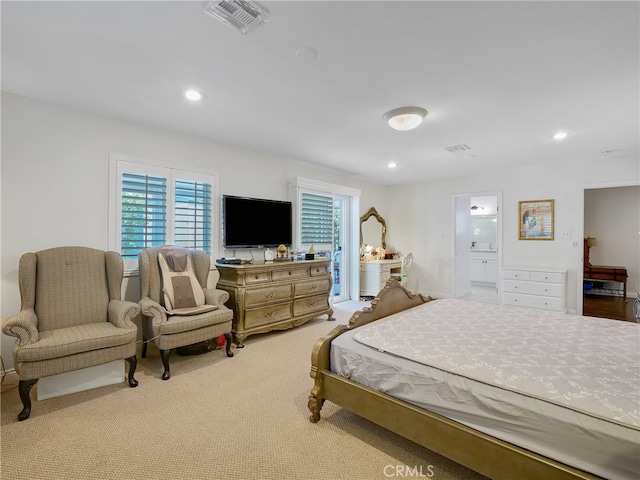 bedroom featuring carpet floors and ensuite bathroom