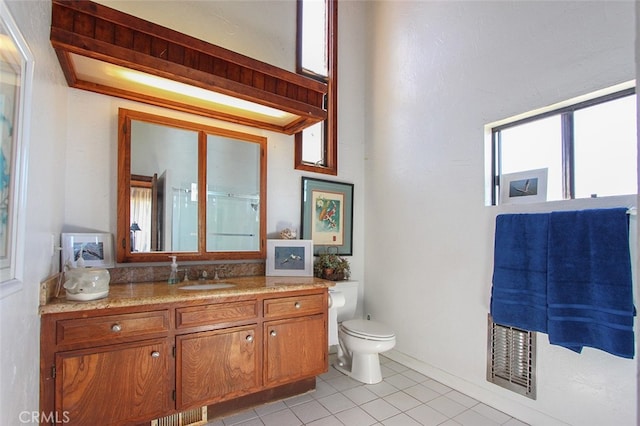 bathroom with walk in shower, tile patterned flooring, vanity, and toilet