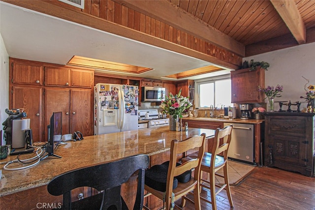 kitchen with wood ceiling, sink, stainless steel appliances, light stone countertops, and dark hardwood / wood-style flooring