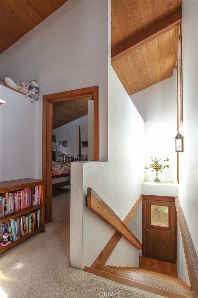 stairs featuring carpet floors, wood ceiling, and lofted ceiling